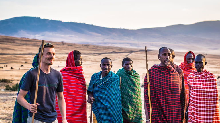 Traveller with men in traditional dress