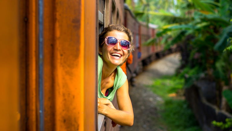 Young woman travelling by train in Sri Lanka