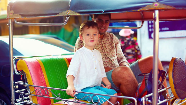 Father and son taking a tuk tuk ride Father and son taking a tuk tuk ride