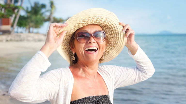 Happy woman traveller on beach