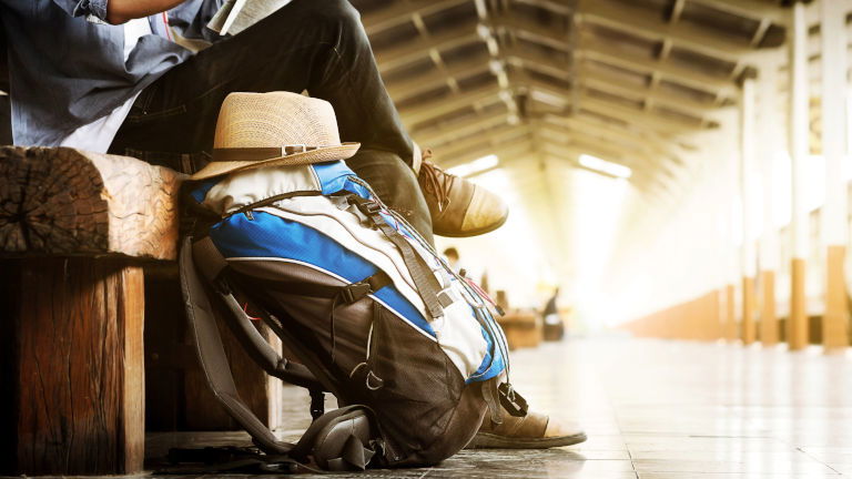 Man with backpack at train station