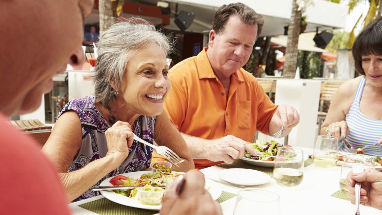 Mature travellers sharing a meal