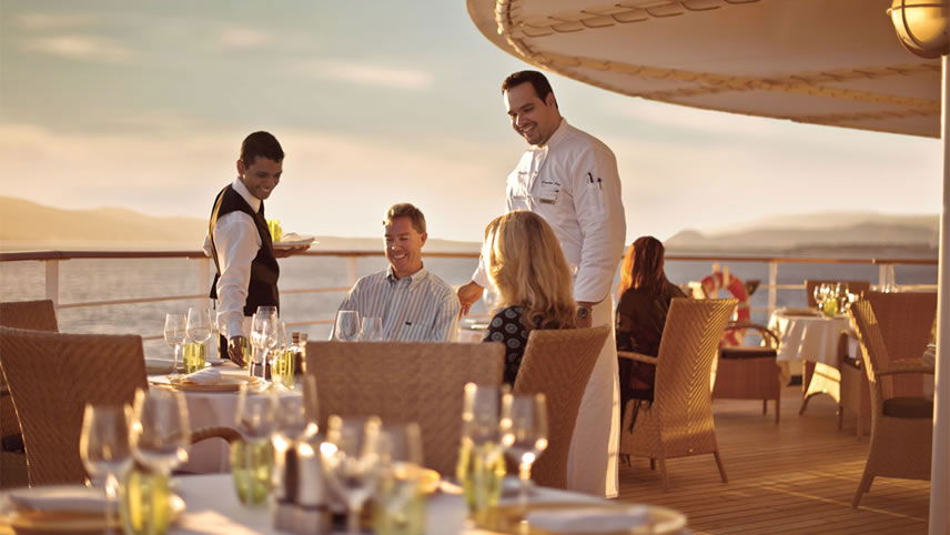 Hotel porter helping traveller with baggage Hotel porter helping traveller with baggage