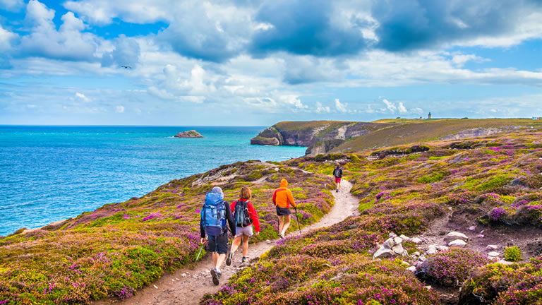 Person in hiking boots with mountains in the background